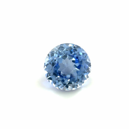 The 8mm Exceptional Round Lab Created Light Blue Sapphire features a brilliant faceted cut and vibrant color, showcased against a plain white background, highlighting its stunning clarity and sparkle.