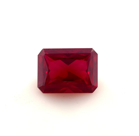 An 8.0x6.0 Exceptional Emerald Radiant Lab Created Ruby, rectangular and faceted with beveled edges, is displayed against a plain white background.