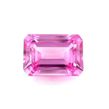 An exceptional 14.0x10.0 emerald-cut lab created medium pink sapphire with sharp facets is displayed on a plain white background.