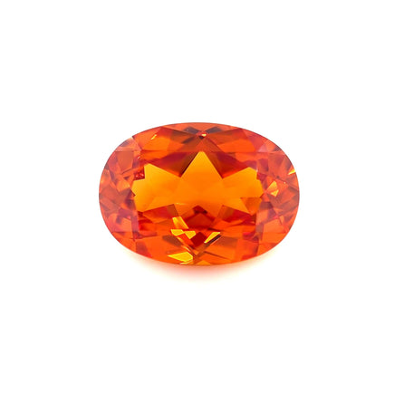 A 14.0x10.0 exceptional oval lab created orange sapphire with intricate facets reflecting light is displayed on a plain white background.