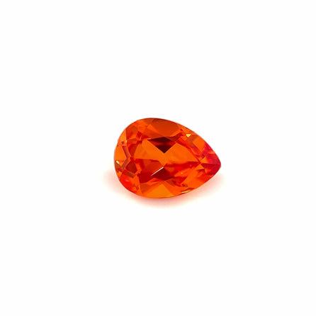 An 8.0x6.0 Exceptional Pear Lab Created Orange Sapphire is displayed on a plain white background, highlighting its vibrant orange color and sparkling faceted surface.