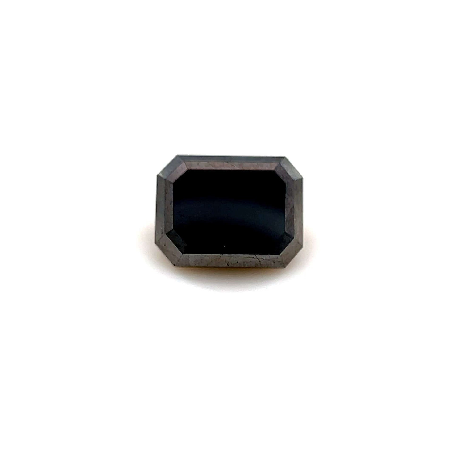The 2.10 carats Emerald 8.0x6.1 Premium Black Diamond, featuring beveled faceted edges, is showcased centered on a white background, highlighting the allure of this natural gemstone.