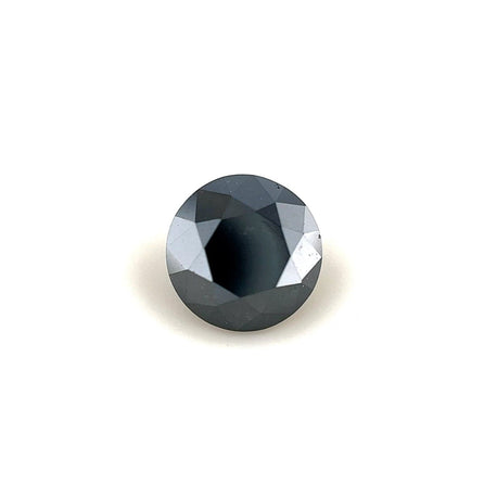 A 1.40 carat, round faceted black diamond (6.65 x 6.65 x 4.87 mm) with a reflective surface is showcased against a plain white background.