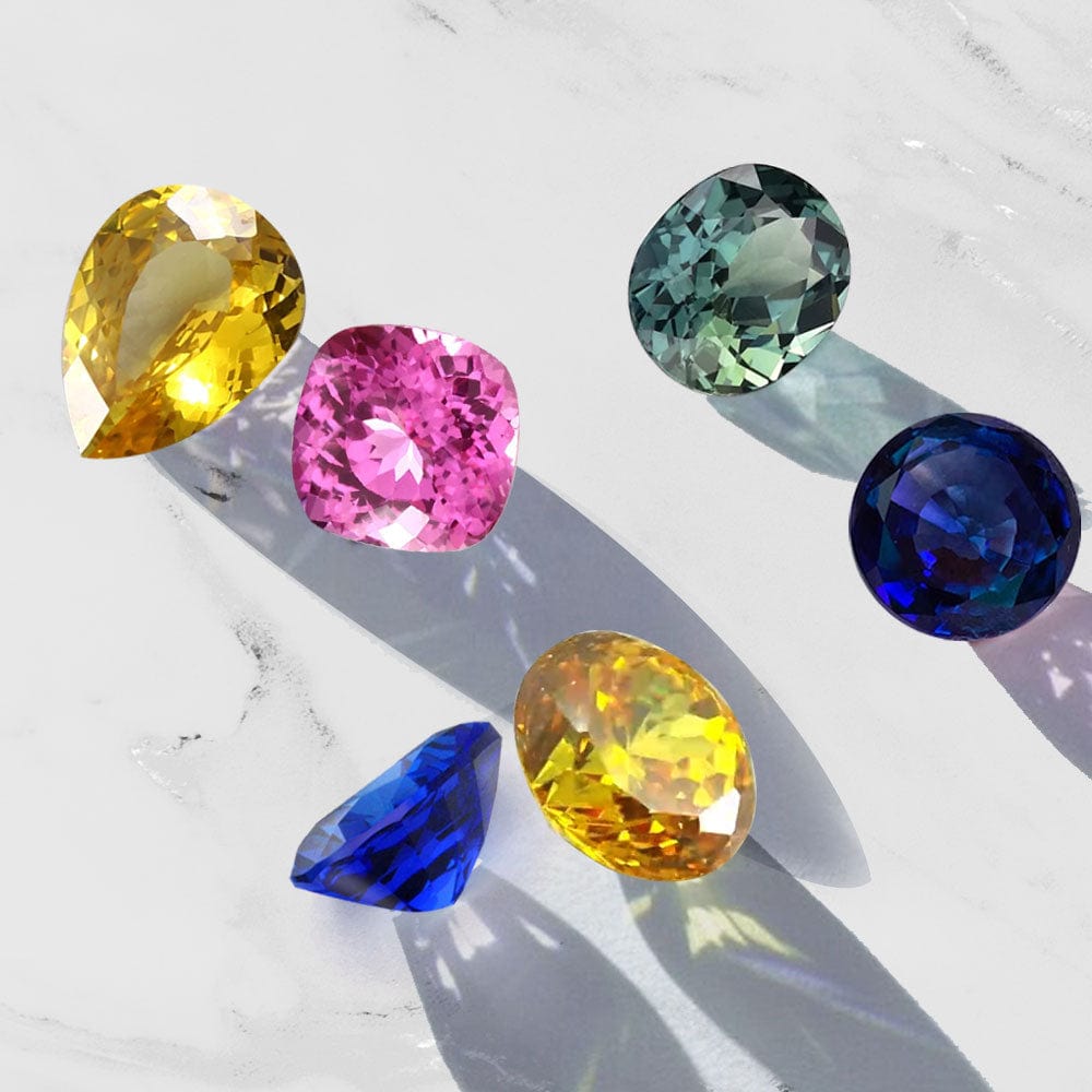 Colorful sapphire gemstones on a light background