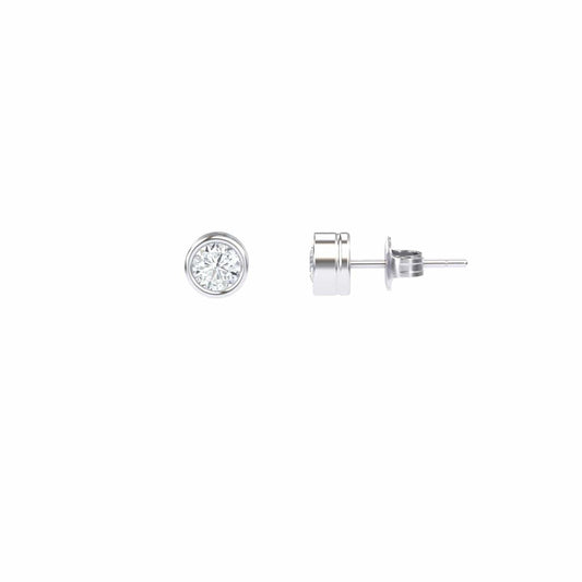 Lab Diamond Earrings - Bezel Set - Ishanvi: A pair of round, bezel-set lab diamond stud earrings with silver posts, displayed from the front and side on a plain white background.