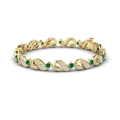 The Emerald & Diamond Swirl Link Bracelet - Elizabeth features an intricate vine-like design, sparkling diamonds, and small green gemstones woven throughout its elegant gold pattern.