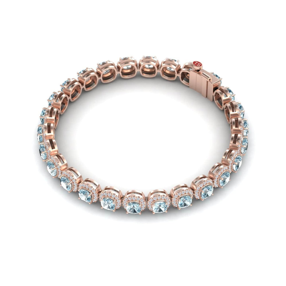 The Aquamarine & Diamond Halo Tennis Bracelet - Isabella features sparkling gemstones in prong settings, showcased on a white background.
