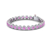 The Isabella Lab Pink Sapphire & Diamond Halo Tennis Bracelet features round pink sapphires in prong settings, accented by diamond halos, and finished with a sleek clasp closure.