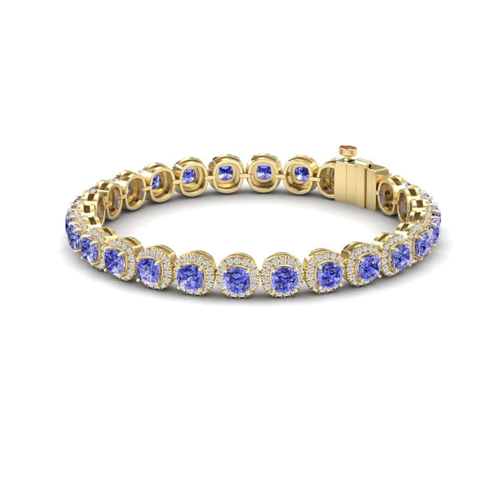 The Tanzanite & Diamond Halo Tennis Bracelet - Isabella features round blue tanzanites, each set in an individual bezel and surrounded by sparkling diamonds, finished with a secure clasp.