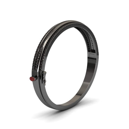 The Bold Black Bangle: Unconventional Elegance - Amalia features two rows of dark gemstones and a red circular accent near the clasp, all set in a sleek black finish and displayed on a white background.