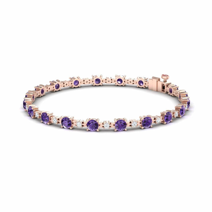 The Amethyst & Diamond Tennis Bracelet - Natalia features evenly spaced round purple gemstones set in rose gold prongs, displayed on a plain white background.