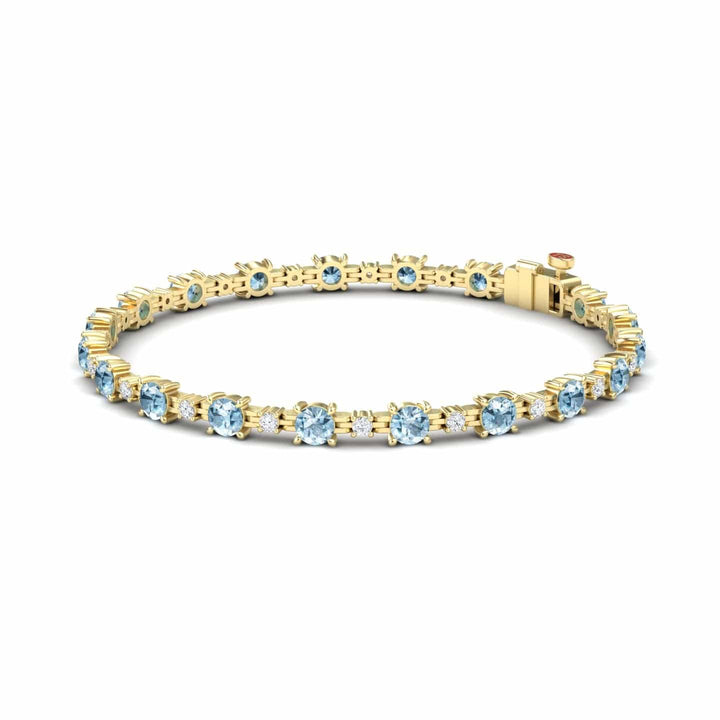 The Aquamarine & Diamond Tennis Bracelet - Natalia features a continuous row of round, light blue aquamarines set in prongs with sparkling diamonds and a secure clasp.