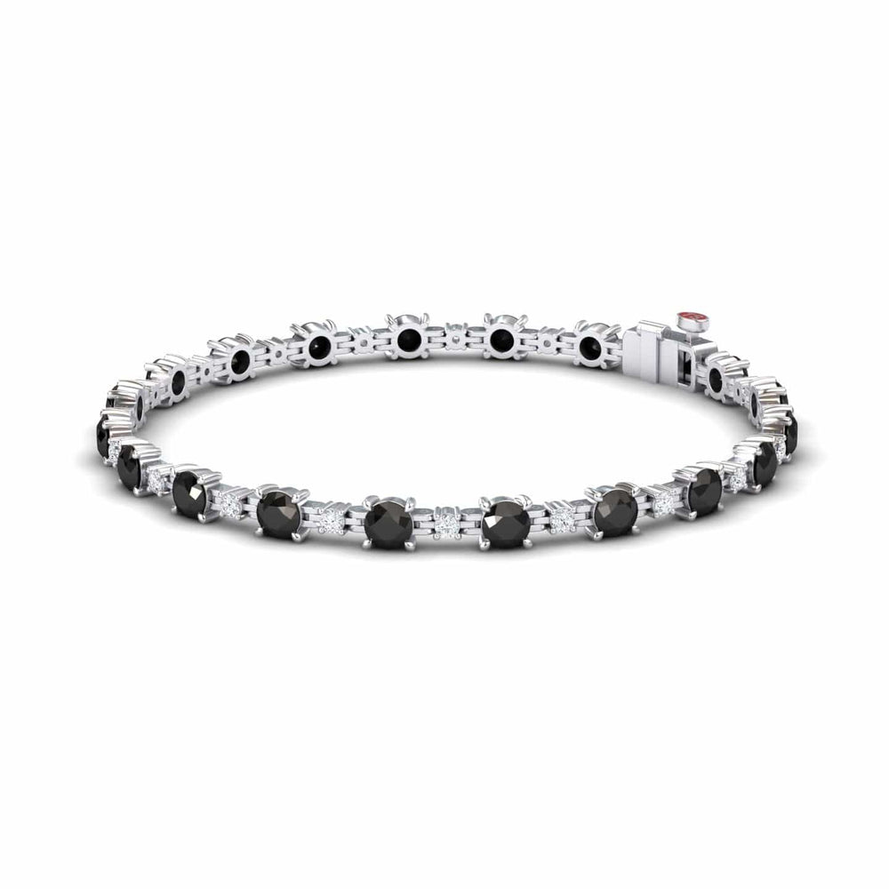 The Black & White Diamond Tennis Bracelet - Natalia features a continuous row of round black gemstones set in prongs, finished with a secure clasp.