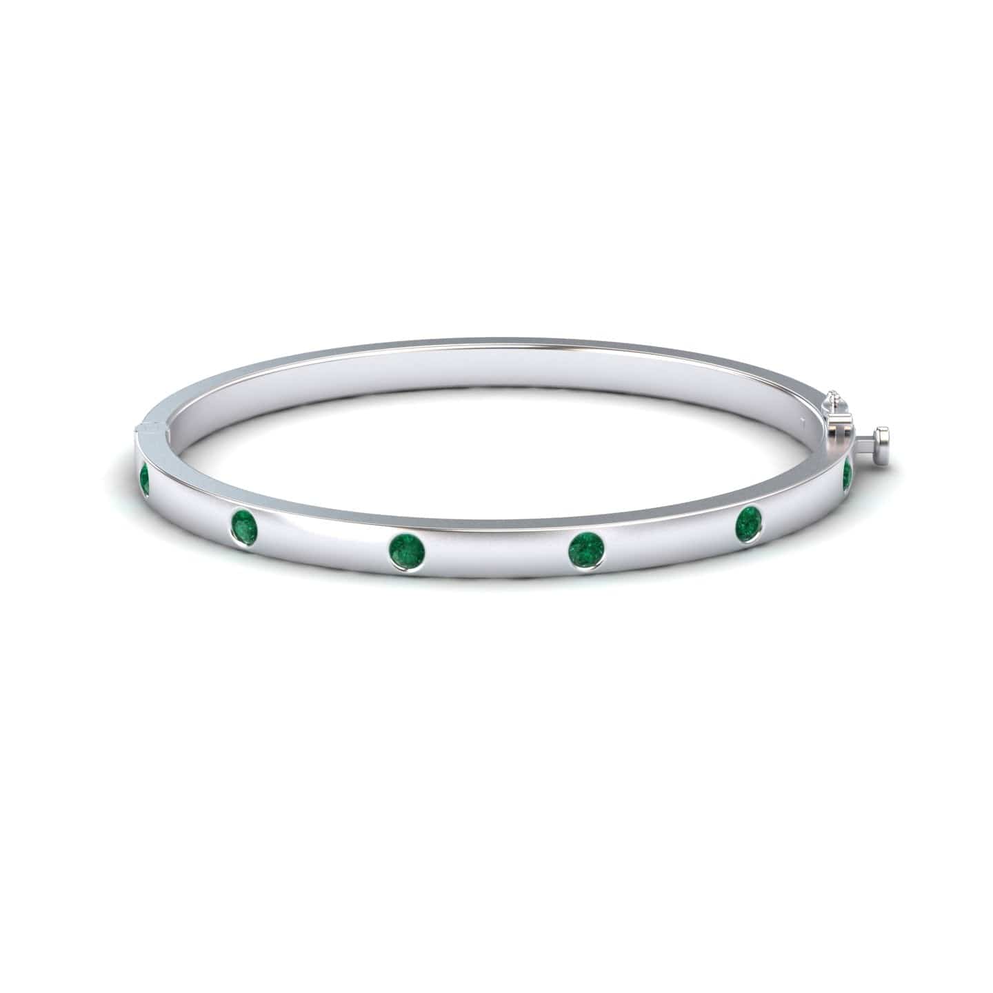 The Emerald Bezel-Set Bracelet - Flavia is a silver bangle adorned with evenly spaced round green gemstones, shown on a white background.