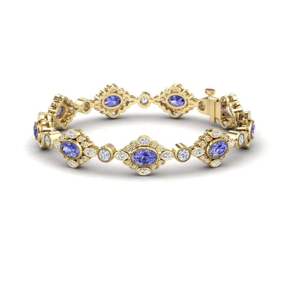 The Tanzanite & Diamond Vintage-Inspired Tennis Bracelet – Ariana features ornate gold diamond-shaped links, each with a central round tanzanite surrounded by sparkling white diamonds for an intricate, elegant look.