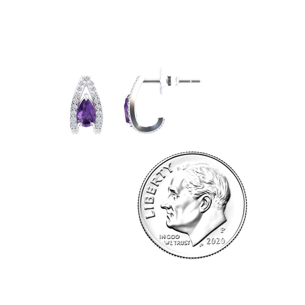 The Amethyst & Diamond Halo Huggie Earrings - Zahra are silver earrings featuring purple amethyst and clear diamond stones, shown with a 2020 U.S. dime for size; one earring is front-facing, the other shows a side view.