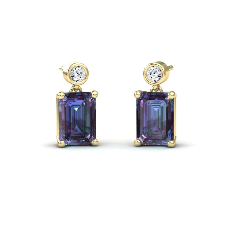 The Lab Grown Alexandrite & White Diamond Drop Earrings - Gracia feature round white diamonds above large emerald-cut alexandrite gemstones, all prong-set and shown on a white background.