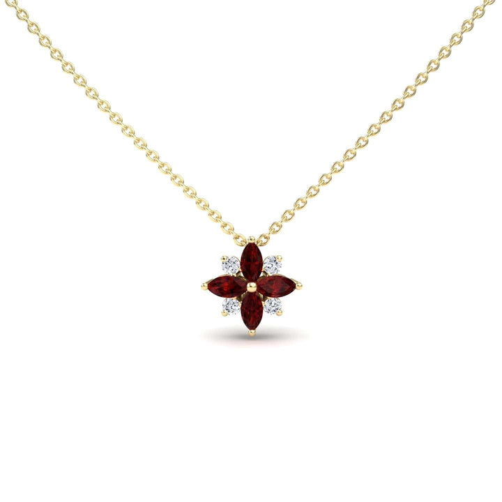 The Ruby & Diamond Flower Necklace - Keira features a gold chain with a flower pendant, adorned with four marquise-cut red gemstones as petals and four round white gemstones in a symmetrical design.