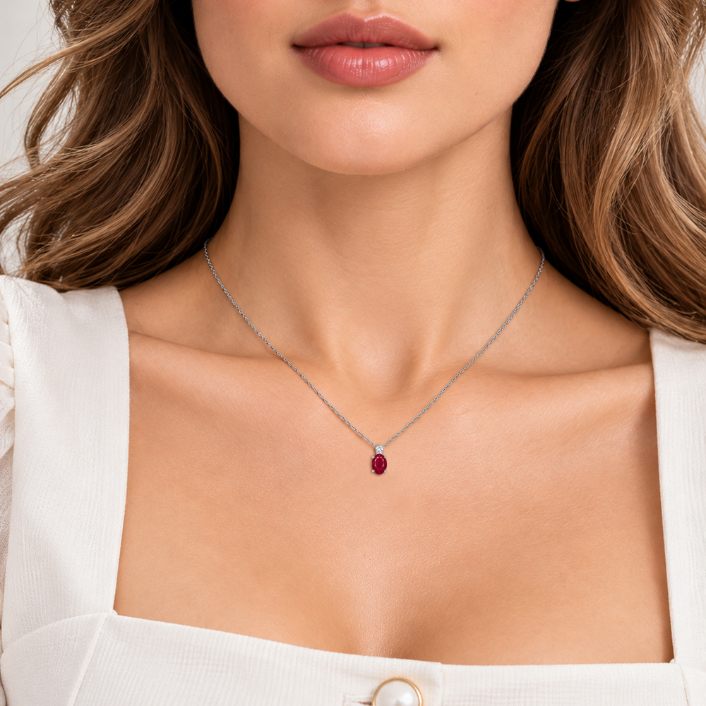 Ruby and diamond oval solitaire necklace in 14k white gold, worn on model