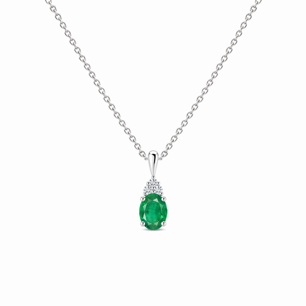 Emerald and trio diamond oval solitaire necklace in 14k white gold