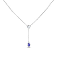 The Tanzanite & Diamond Elegant Drop Necklace - Daniela features a minimalist silver chain with a central round diamond and a short drop ending in a pear-shaped tanzanite gemstone pendant, offering an elegant and refined look.