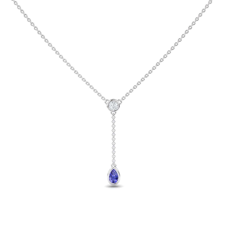 The Tanzanite & Diamond Elegant Drop Necklace - Daniela features a minimalist silver chain with a central round diamond and a short drop ending in a pear-shaped tanzanite gemstone pendant, offering an elegant and refined look.