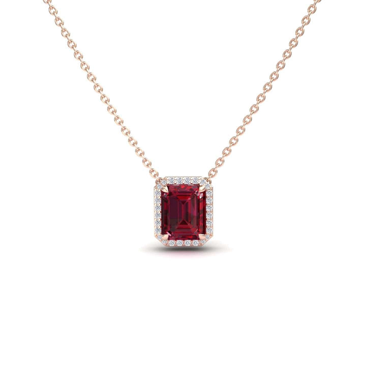 The Ruby & Diamond Halo Necklace - Hilary is a gold chain necklace with a rectangular red gemstone pendant encircled by small white diamonds, shown against a white background.