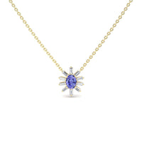 The Tanzanite & Diamond Starburst Necklace - Laura features a gold chain with a central oval blue gemstone and radiating baguette-cut clear stones in a starburst design, displayed against a white background.