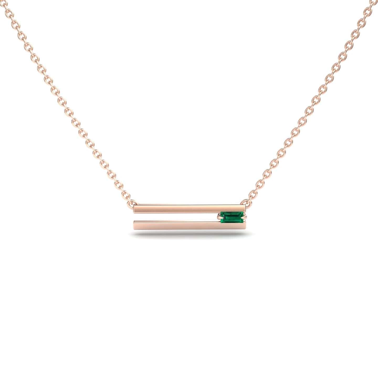 The Emerald Bar Necklace - Cecilia is a delicate rose gold necklace with two horizontal bars, the top bar set with a small rectangular green gemstone, displayed against a plain white background.