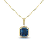 The London Blue Topaz & Diamond Halo Necklace - Sanya features a gold chain with a square-cut blue topaz pendant, surrounded by white diamonds and accented with more diamonds on the bail.