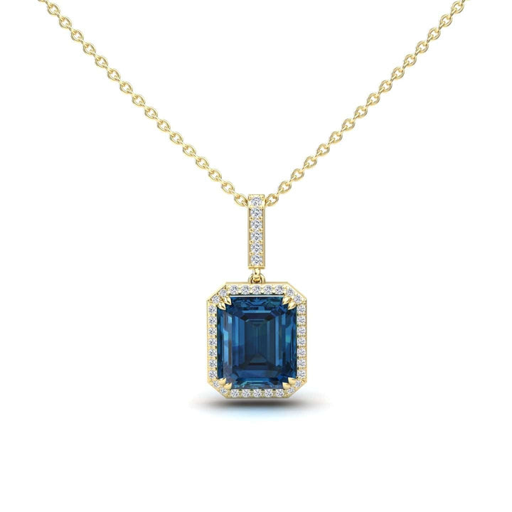 The London Blue Topaz & Diamond Halo Necklace - Sanya features a gold chain with a square-cut blue topaz pendant, surrounded by white diamonds and accented with more diamonds on the bail.