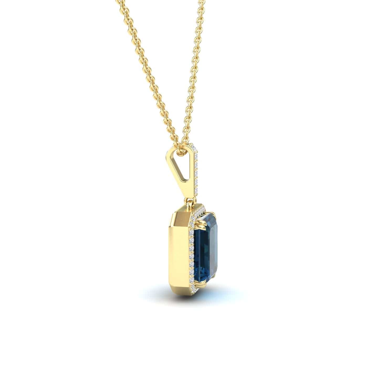 The London Blue Topaz & Diamond Halo Necklace - Sanya features a gold chain and a rectangular blue topaz pendant with diamond accents, shown from a side view on a white background.