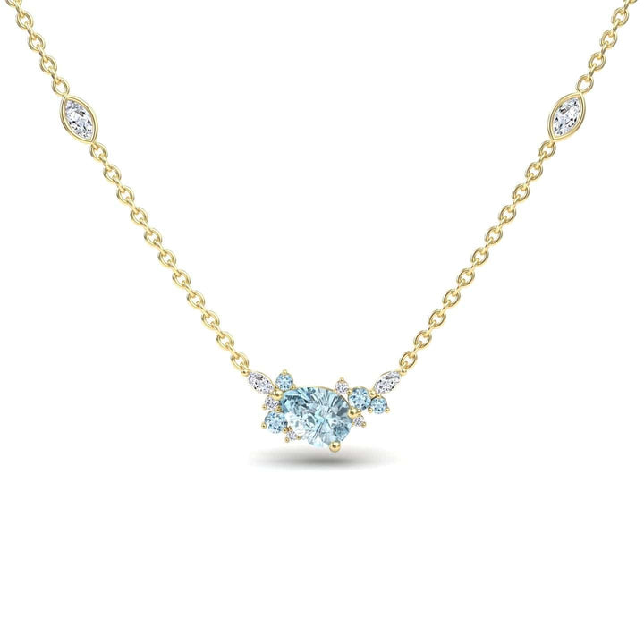 The Aquamarine & Diamond Bouquet Necklace - Daria features a gold chain with a central heart-shaped aquamarine surrounded by diamonds and two marquise-cut gemstone accents on each side.