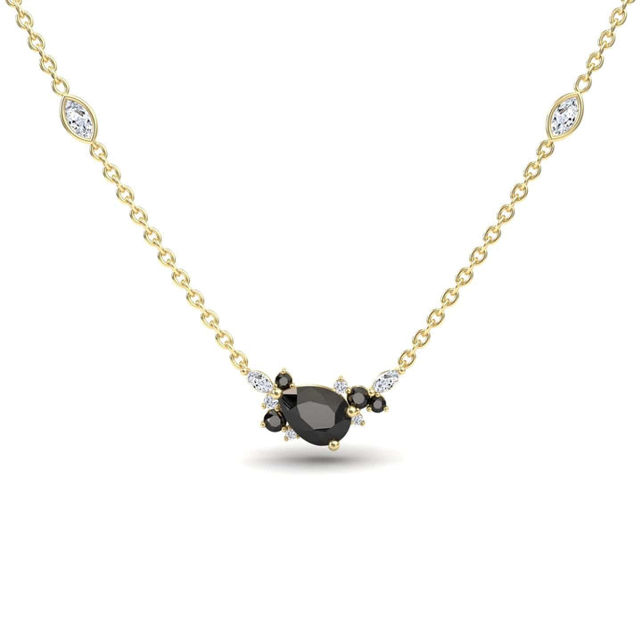 The Black & White Diamond Bouquet Necklace – Daria features a gold chain with a central oval black gemstone, surrounded by black and white stones, plus two marquise-shaped white stones set along the chain.