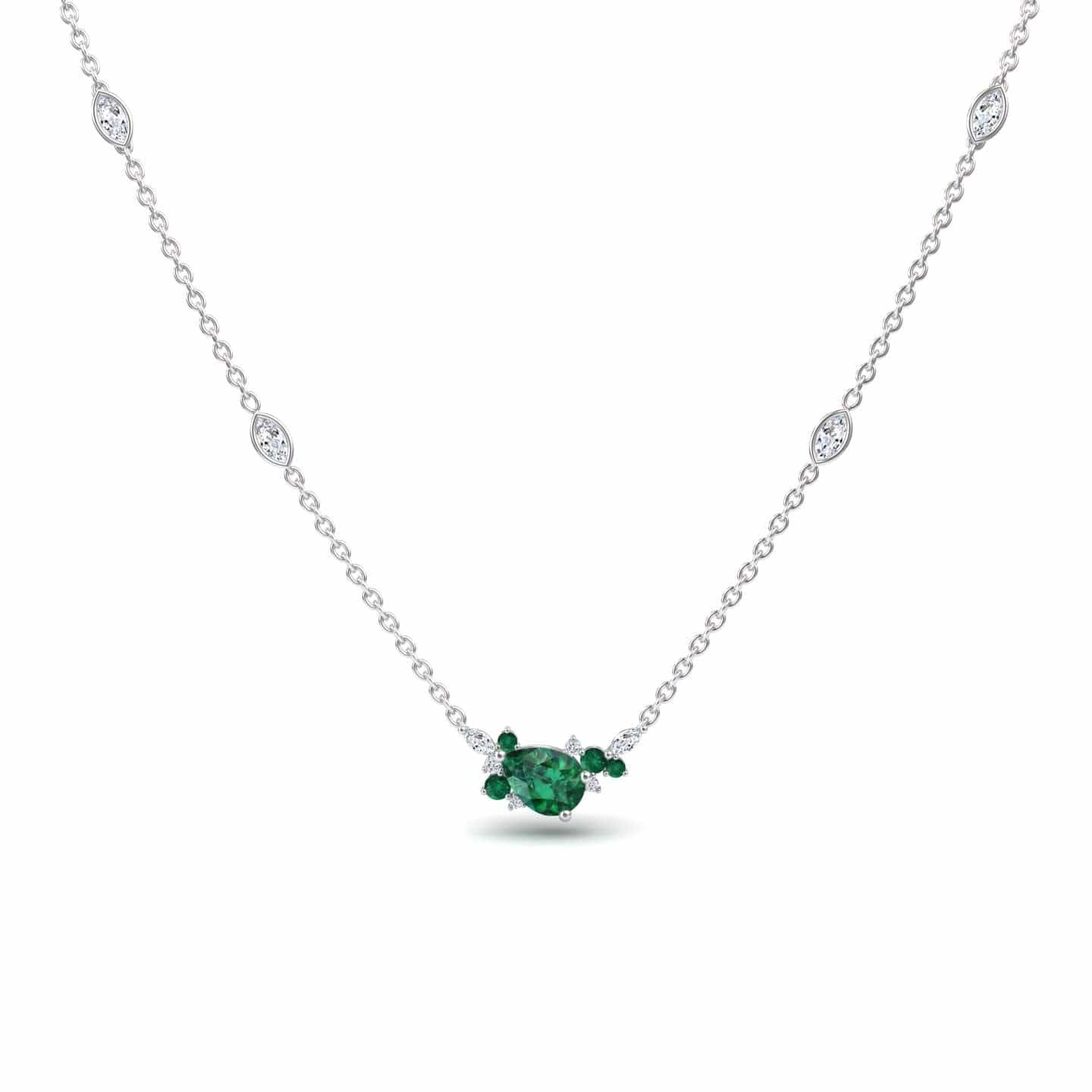 The Emerald & Diamond Bouquet Necklace - Daria is a delicate silver piece with a central oval green gemstone, two smaller side stones, and four small round white gems elegantly spaced along the chain.