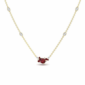 The Ruby & Diamond Bouquet Necklace - Daria showcases a central red gemstone encircled by smaller red and clear stones, with more sparkling clear stones set along its elegant gold chain.