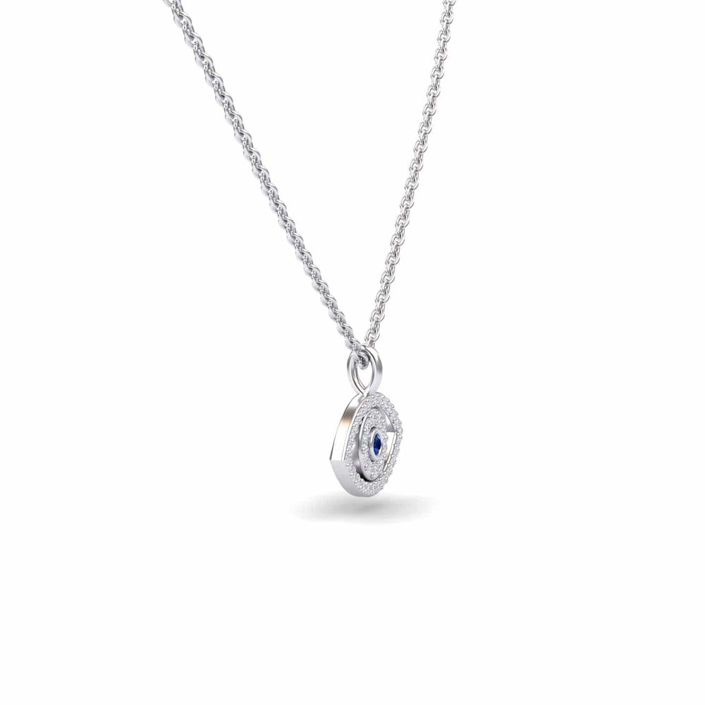 The Blue Sapphire & Diamond Eye Necklace - Elise features a silver chain with a circular pendant, showcasing a blue sapphire center stone encircled by sparkling diamonds, displayed on a plain white background.