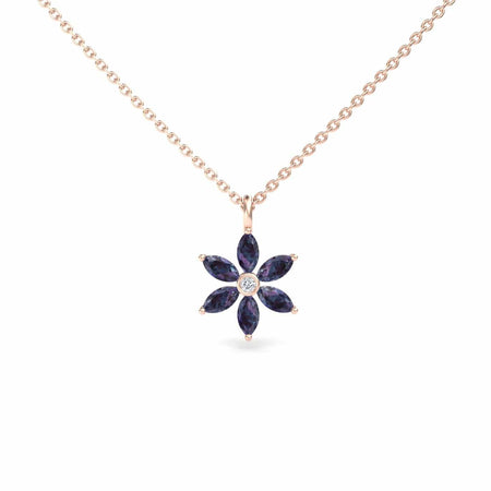 The Erin Lab Grown Alexandrite & Diamond Floral Necklace features a gold chain with a flower-shaped pendant, set with six dark blue marquise alexandrites and a central round diamond.