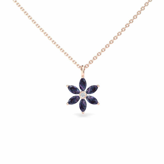 The Erin Lab Grown Alexandrite & Diamond Floral Necklace features a gold chain with a flower-shaped pendant, set with six dark blue marquise alexandrites and a central round diamond.