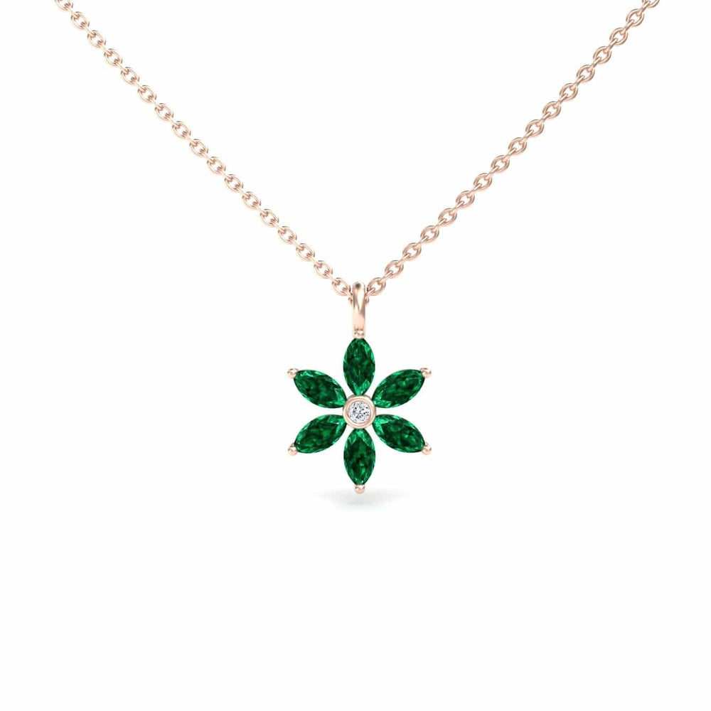 The Lab Grown Emerald & Diamond Floral Necklace - Erin features a gold chain with a flower pendant showcasing six marquise-cut green emeralds as petals and a round white diamond at the center.