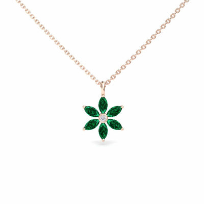 The Lab Grown Emerald & Diamond Floral Necklace - Erin features a gold chain with a flower pendant showcasing six marquise-cut green emeralds as petals and a round white diamond at the center.