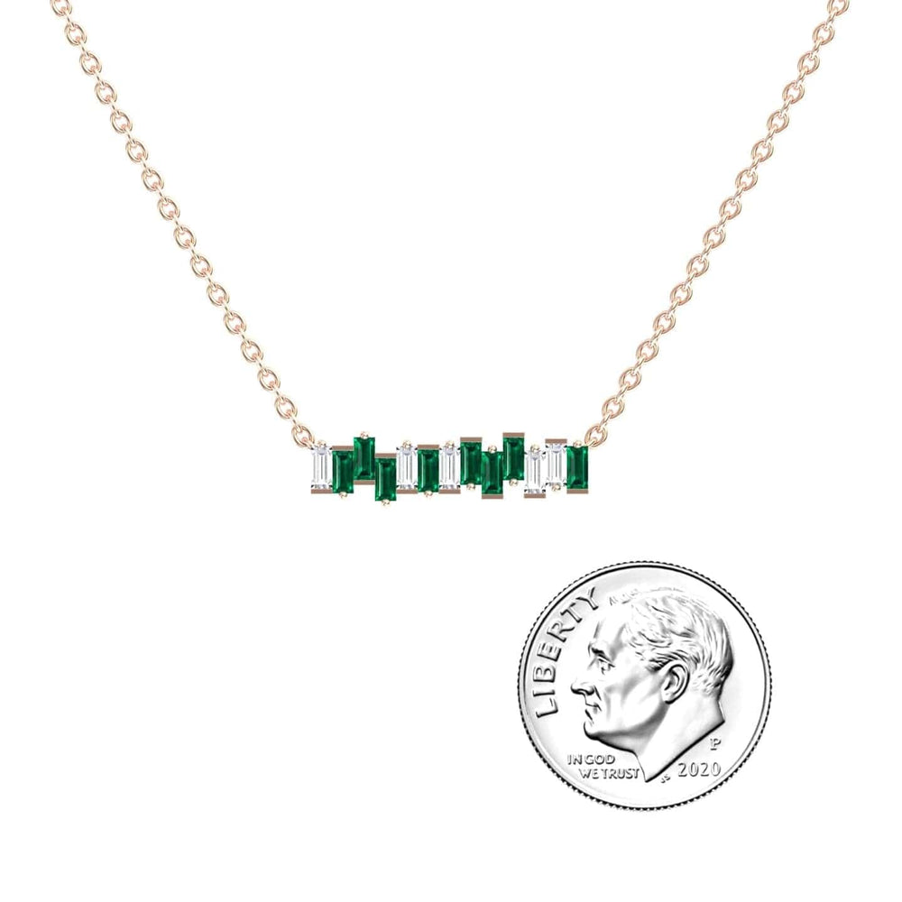 The Lab Grown Emerald & Diamond Geometric Bar Necklace - Fernanda is a gold chain necklace with a horizontal bar pendant featuring alternating green and clear rectangular stones, shown next to a 2020 U.S. dime for size comparison.