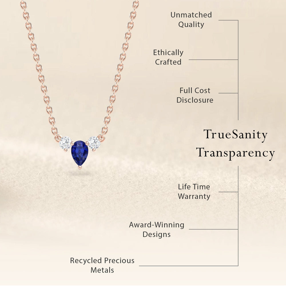 The Blue Sapphire & Diamond Three-Stone Necklace - Jina features a delicate gold chain with a blue sapphire teardrop and two diamonds. Crafted ethically from recycled precious metals, it offers unmatched quality, transparent pricing, lifetime warranty, and award-winning design.