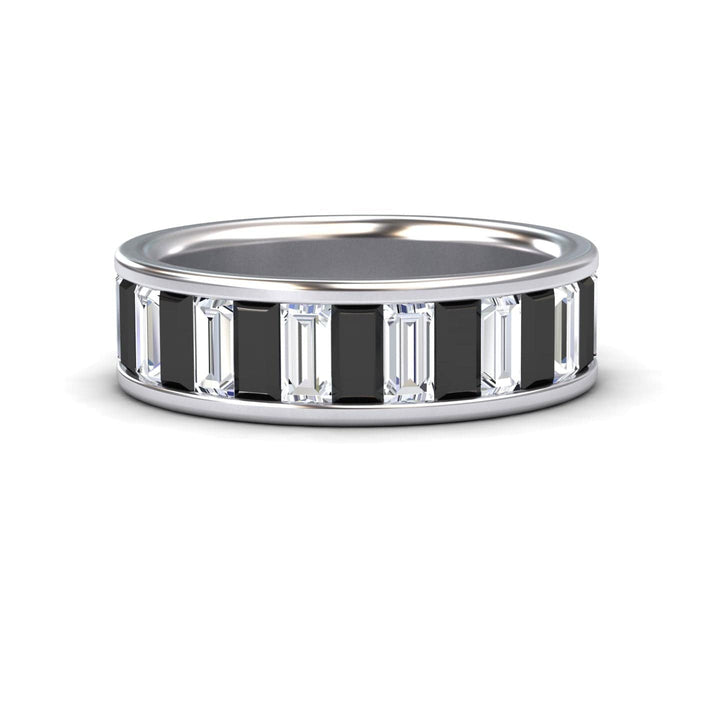 The Kyra Black & White Diamond Channel-Set Eternity Band is a silver ring with alternating rectangular black and clear baguette-cut stones in a continuous pattern around the band.