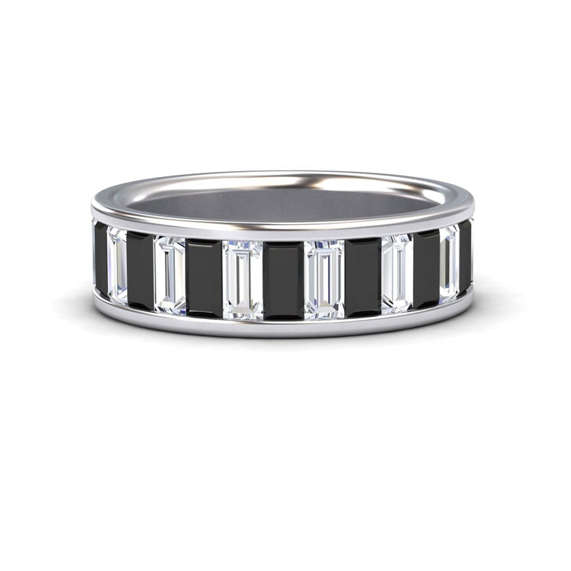 The Kyra Black & White Diamond Channel-Set Eternity Band is a silver ring with alternating rectangular black and clear baguette-cut stones in a continuous pattern around the band.