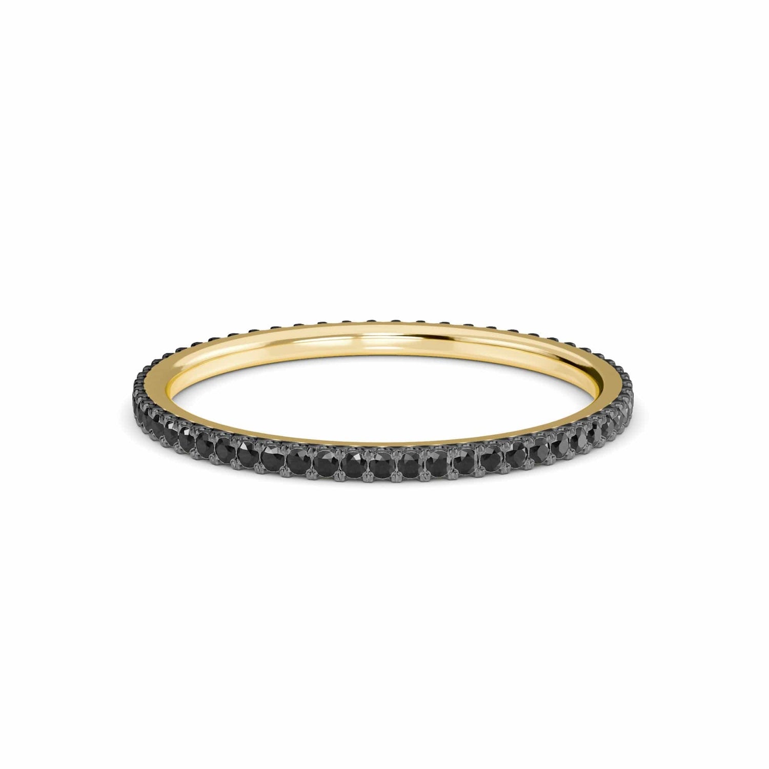 The Black Diamond Ballad Eternity Ring - Colleen features a slim gold band adorned with a continuous row of small, round black diamonds, shown against a plain white background.