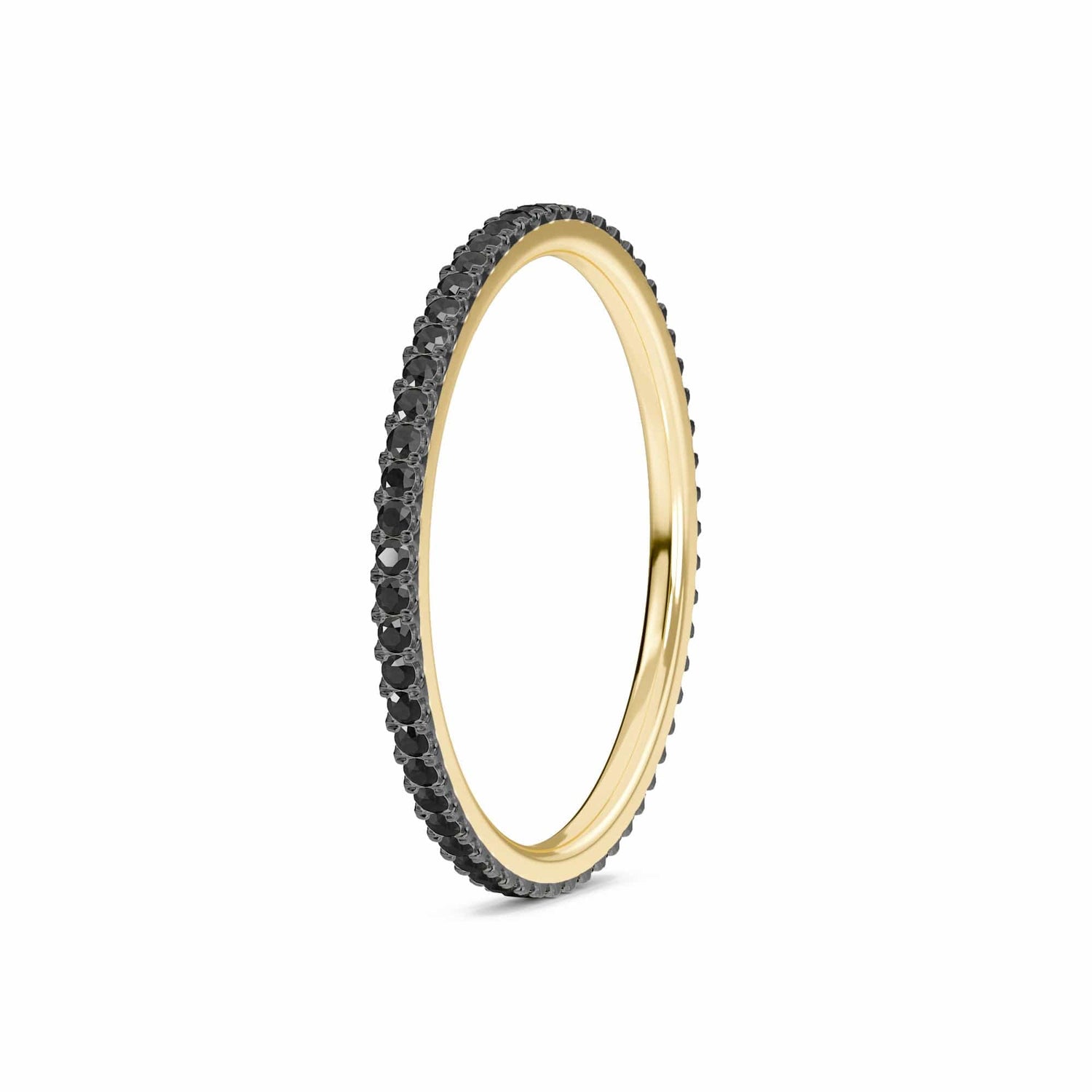 The Black Diamond Ballad Eternity Ring - Colleen features a slim gold band adorned with a full circle of small black stones, displayed on a white background.