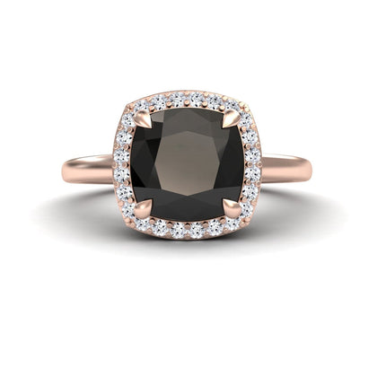 The Black & White Diamond Halo Ring - Ziva showcases a large cushion-cut black gemstone encircled by a halo of white diamonds, set on a sleek rose gold band.
