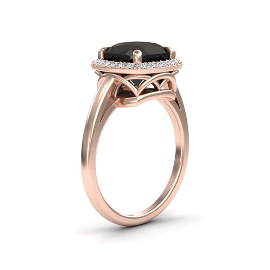 The Black & White Diamond Halo Ring - Ziva features a large round black gemstone at the center, encircled by a halo of white diamonds and set on an intricately designed rose gold band.