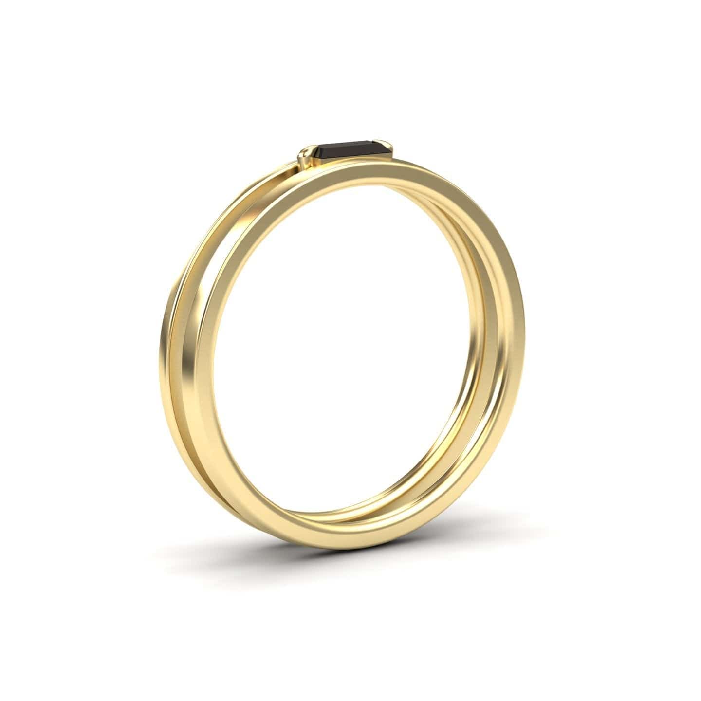 The Alia Black Diamond Minimalist Double Band Ring features a slim gold band with a small rectangular black diamond, showcased on a plain white background.